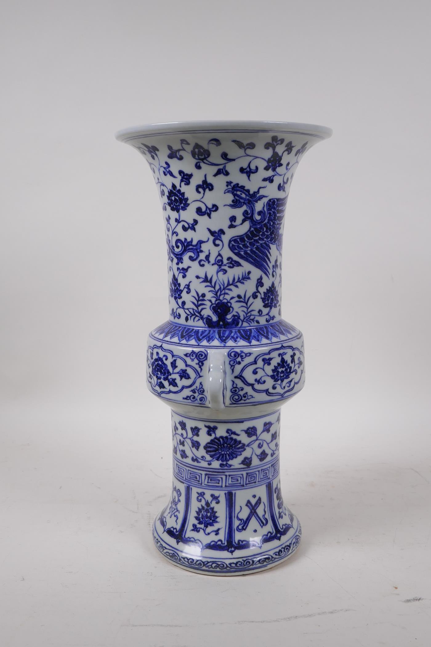 A Chinese Ming style blue and white porcelain gu shaped vase with two handles decorated with a - Image 2 of 6