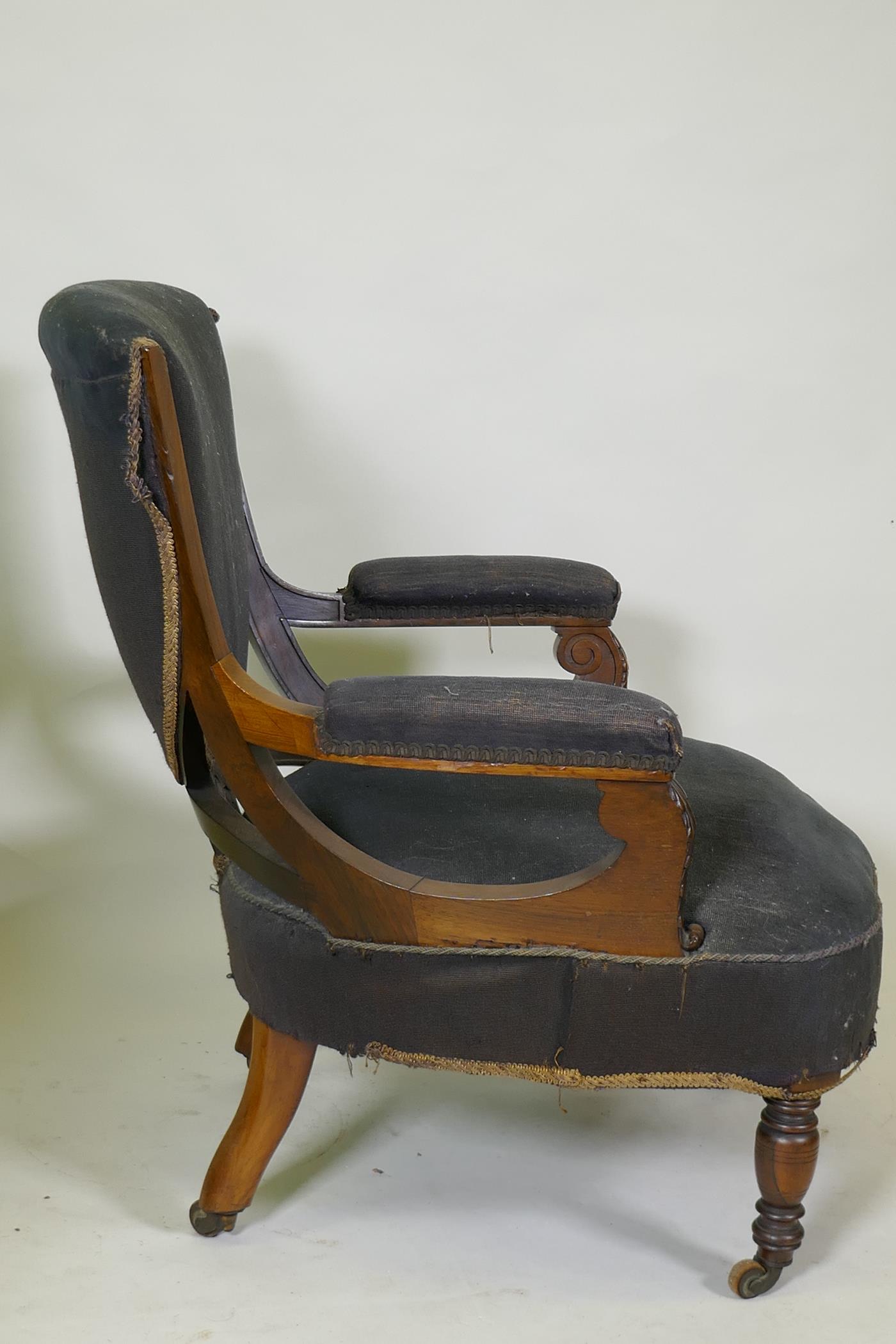 A Victorian show frame rosewood arm chair, with carved arms, raised on turned supports with brass - Image 5 of 5