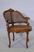 A C19th French walnut tub chair with crisply carved decoration, scroll crest and scrolling arms,