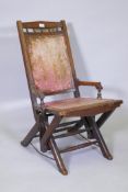 A late C19th mahogany framed rocking chair with metal strap rocker supports