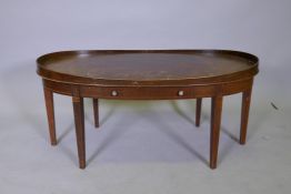 An inlaid mahogany single drawer coffee table with an oval top and gallery, 99 x 51cms, 45cm high