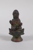 A Tibetan bronze figure of Buddha seated on a lotus flower, 6cm high