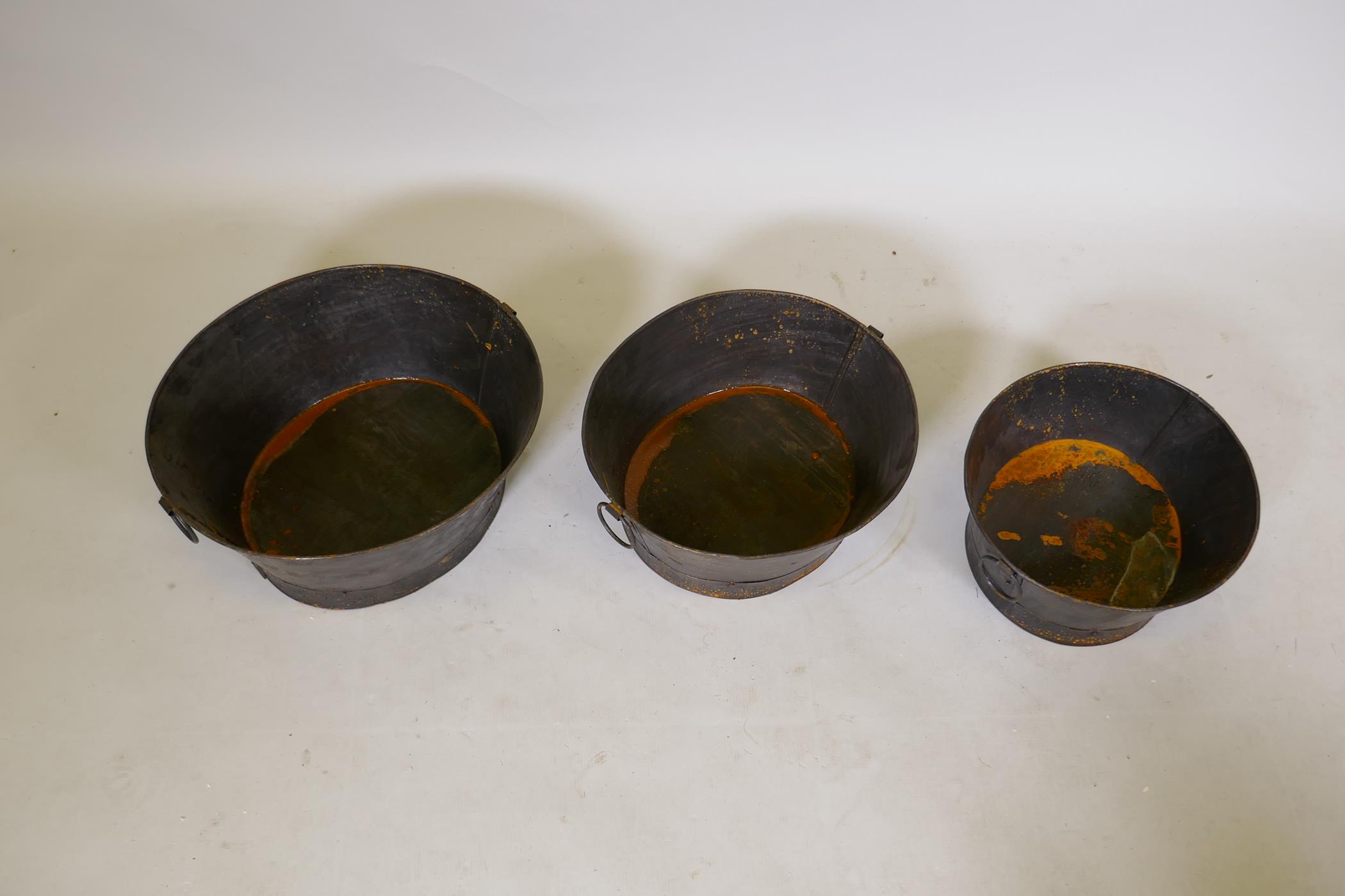 A set of three graduated oval metal planters each with two ring handles, largest 44 x 40cm - Image 2 of 2