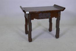 An early C20th Chinese teak low table with scroll end top and carved decoration, 62 x 36 x 49cms