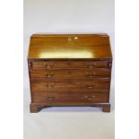 A large Georgian mahogany fall front bureau with fitted interior over four long graduated drawers