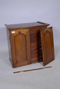 A C19th Anglo Indian flight of collectors drawers, with arched panelled doors, AF 1 detached, 62 x