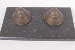 A Trench Art inkwell made from two shell heads mounted on a marble base, 27cm wide