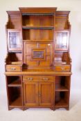 A Heal & Son Arts and Crafts walnut side cabinet, the upper section with open shelves and glazed