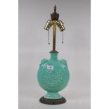 A green glaze porcelain table lamp in the form of an oriental flask, 58cm high