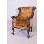 A C19th American carved walnut framed easy chair, with shaped and scrolled back and arms, raised
