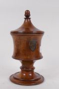 A treen turned fruitwood tobacco jar/tea caddy with cover and painted heraldic shield, 25cm high