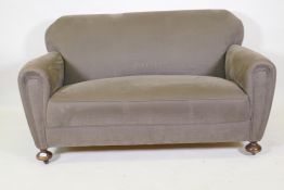 An Art Deco settee, well upholstered in a neutral fabric, 145cm wide