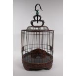 A Chinese bird cage with carved decorative frieze depicting birds and squirrels amongst foliage,