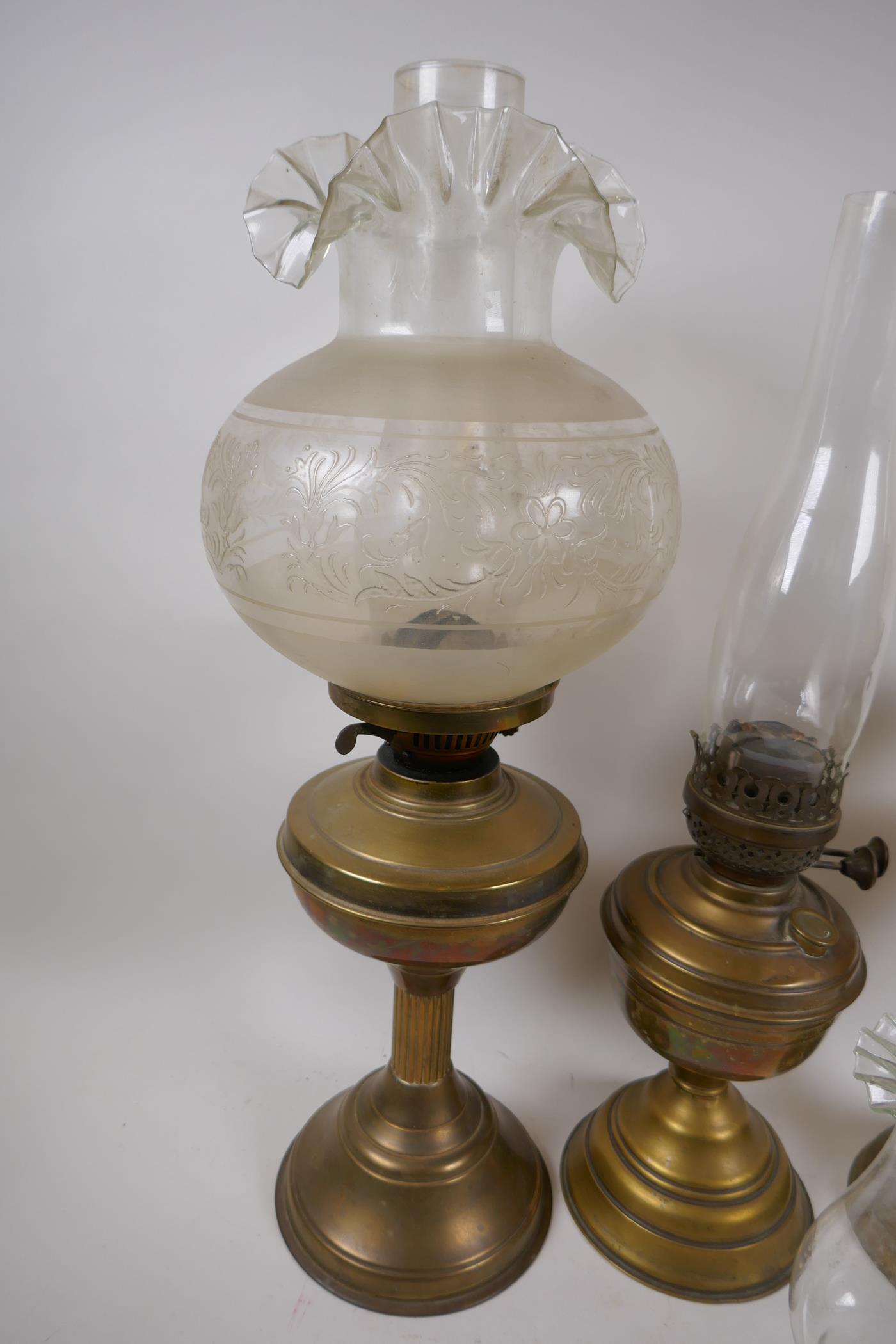 A near pair of brass column oil lamps and another similar, with one engraved shade and various - Image 4 of 4