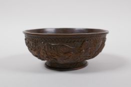 A bronze bowl with raised dragon decoration, impressed Chinese KangXi 4 character mark to base, 11cm