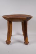 An African carved hardwood fertility stool, 32cm high x 36cm diameter