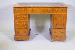 A mahogany nine drawer pedestal desk with inset top, 105 x 55cms, 73cm high