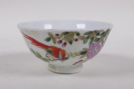 A polychrome porcelain tea bowl with bird and flower decoration, character inscription verso,