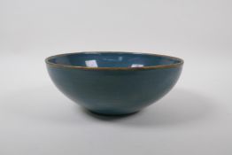 A Chinese celadon glazed porcelain bowl with a gilt metal rim, and the interior with chased and gilt