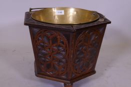 A C19th Dutch carved oak wine cooler with brass liner, 34cm diameter x 30cm