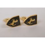A pair of gilt metal cufflinks decorated with the Ferrari badge