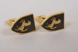 A pair of gilt metal cufflinks decorated with the Ferrari badge