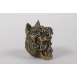 A brass vesta case in the form of a skull wearing a wolf's head hat, 5cm