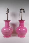 A pair of pink glazed ceramic table lamps, 66cm high