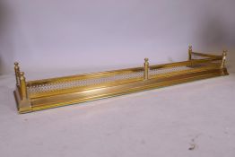 A pierced brass fender, 148cm x 40cm x 19cm