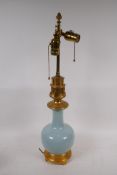 A celadon glazed porcelain table lamp with brass mounts, 63cm high