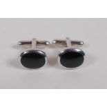 A pair of silver and black agate set cufflinks