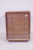 A mahogany veneered naturalist collector's cabinet, with glazed door and eleven slide drawers,