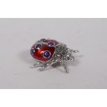A 925 silver and red enamel ladybird brooch, set with marcasite and purple stones, 3cm x 3cm