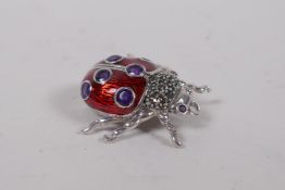 A 925 silver and red enamel ladybird brooch, set with marcasite and purple stones, 3cm x 3cm