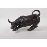 A Chinese filled bronze of a buffalo, 27cm long