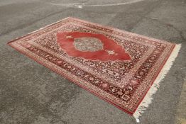 A Belgian wool oriental style carpet with a deep rust brown ground, 200cm x 300cm