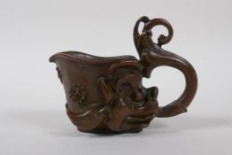 A Chinese bronze libation cup with dragon head decoration, 8 cm high