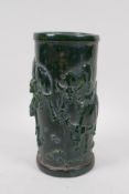 A Chinese reconstituted green hardstone brush pot with raised buffalo decoration, mark to base, 20cm