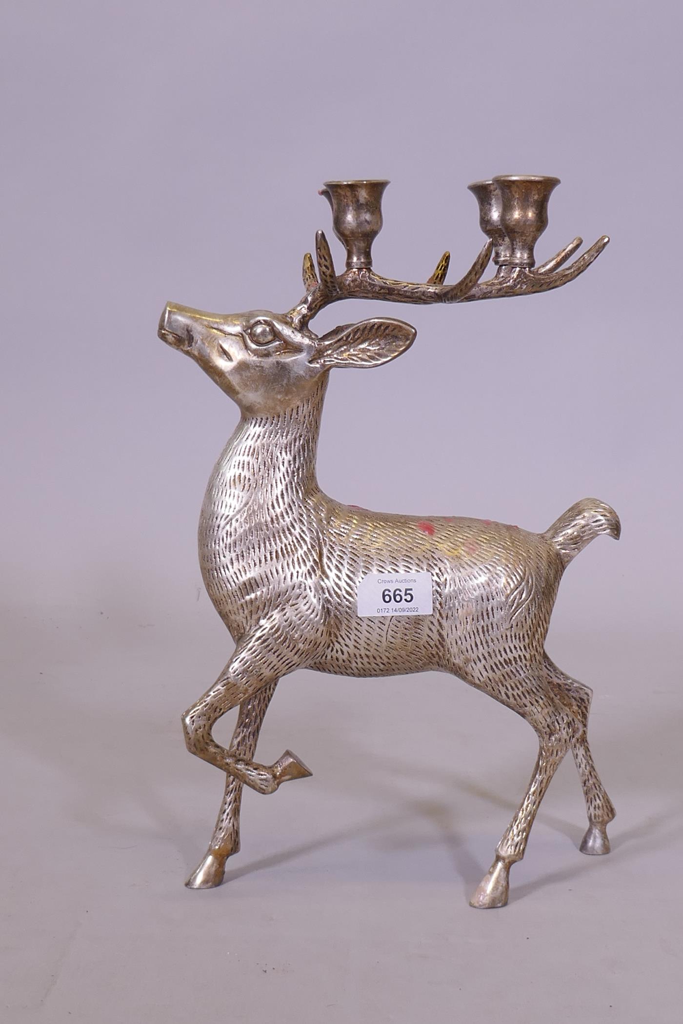 A silver plated four branch candelabum in the form of a stag, 36cm high