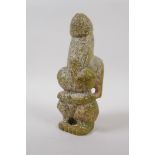 An oriental carved green hardstone fertility figure, 21cm high