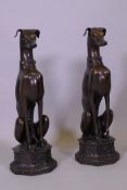 A large pair of bronze greyhounds seated on octagonal plinths, in the manner of Alfred Barye, 74cm
