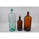 Two vintage brown ribbed glass poison bottles and a similar green glass bottle, largest 39cm high