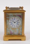 A miniature brass carriage clock decorated with Sevres style panels, 6cm high