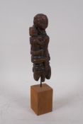 An antique Indian Naga tribe carved wood maternity figure, 31cm high