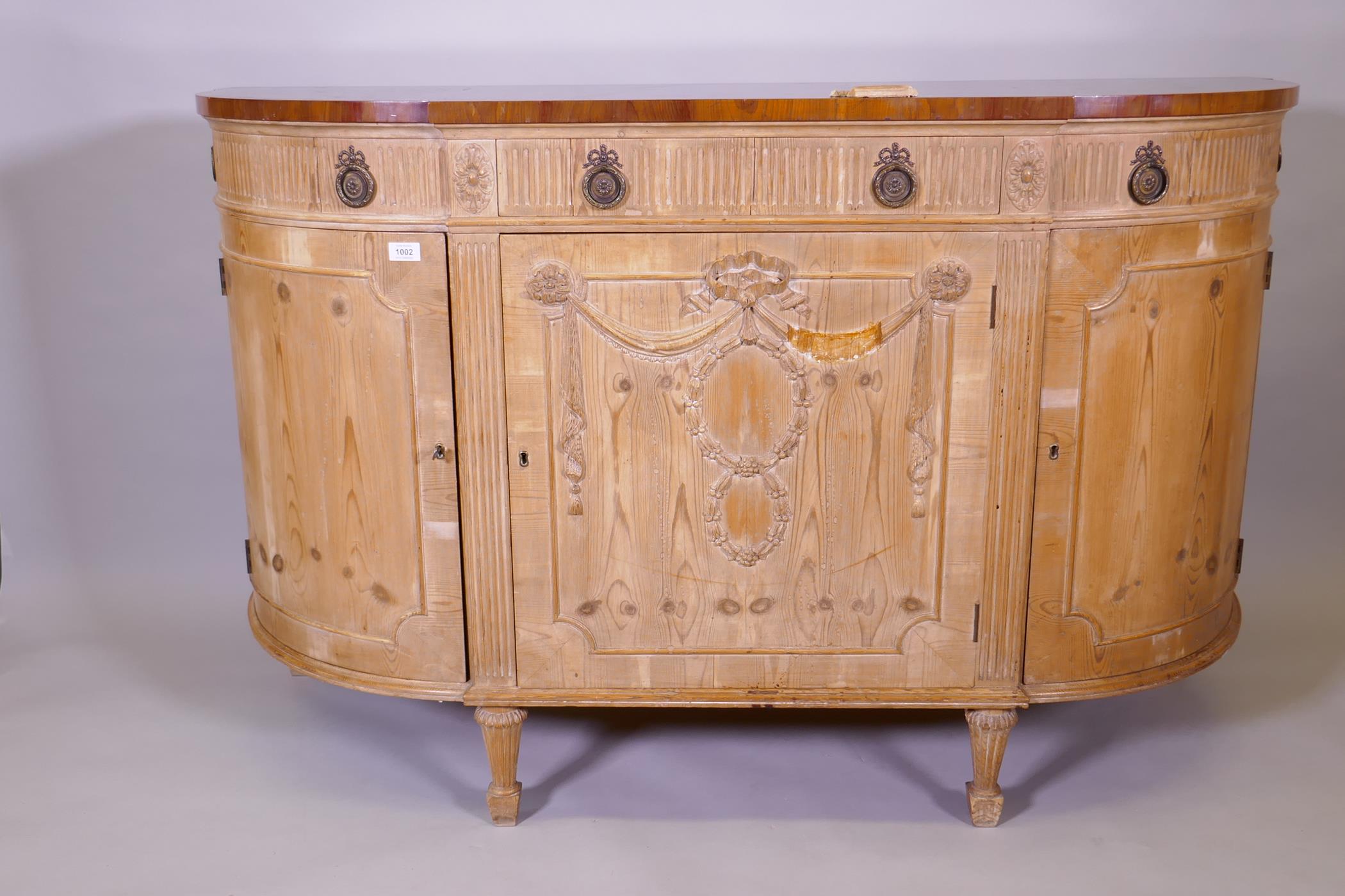 A 'D' shaped breakfront pine commode with crossbanded yew wood veneered top, the fluted frieze