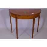 A Sheraton revival style Satinwood demi lune card table with painted decoration raised on square