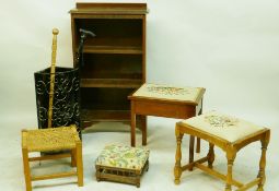 An oak open bookcase, a satin mahogany sewing stool and similar stool, a mahogany foot stool with