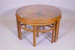 A mid century Nathan furniture 'Trinity' teak and glass nest of tables, largest