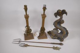 A cast brass dolphin doorstop, 36cm high, a pair of brass ribbed column table lamps and two toasting