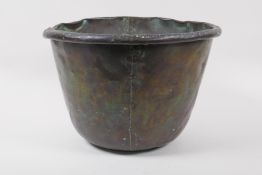 An antique riveted copper bucket, 29cm diameter